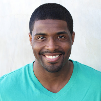 An elderly couple sharing a joyful moment, smiling at the camera with a warm embrace.