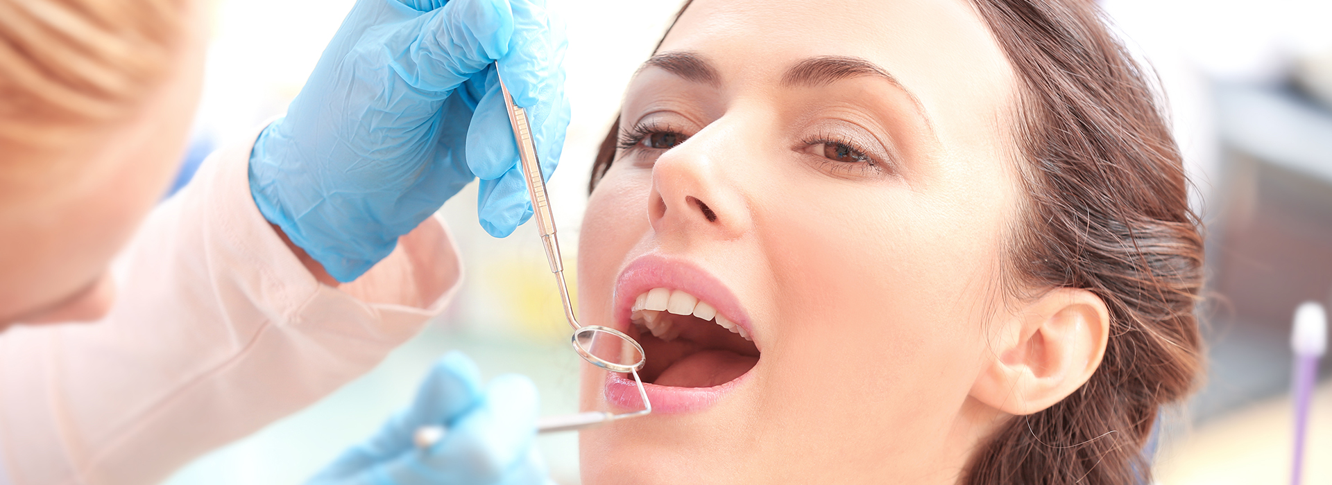 An image of a dental professional performing a procedure on a patient, with a focus on the precision and care involved in dental work.